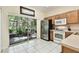 Bright kitchen with stainless steel refrigerator and sliding glass doors to the patio at 2347 Willimette Dr, Wesley Chapel, FL 33543