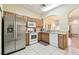 Well-lit kitchen with stainless steel appliances and tiled floors, adjacent to the entryway at 2347 Willimette Dr, Wesley Chapel, FL 33543