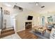 Inviting living room with hardwood floors, staircase, and media center at 2347 Willimette Dr, Wesley Chapel, FL 33543