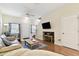 Bright living room with a ceiling fan, hardwood floors, and a comfortable seating area at 2347 Willimette Dr, Wesley Chapel, FL 33543