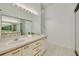Bright bathroom featuring double sinks, a large mirror, and a neutral color palette at 3044 Red Oak Ct # 204, Palm Harbor, FL 34684