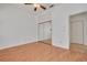 Spacious bedroom featuring hardwood floors, a mirrored closet, and ceiling fan at 3044 Red Oak Ct # 204, Palm Harbor, FL 34684
