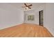 This bright bedroom has beautiful wood floors, a ceiling fan, and access to the screened-in patio at 3044 Red Oak Ct # 204, Palm Harbor, FL 34684