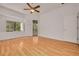 Bright and airy bedroom with beautiful hardwood floors, large windows, a ceiling fan and a slider to the screened porch at 3044 Red Oak Ct # 204, Palm Harbor, FL 34684
