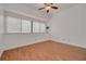 Bedroom featuring a large window offering natural light, ceiling fan, and neutral color palette at 3044 Red Oak Ct # 204, Palm Harbor, FL 34684
