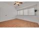 Bedroom featuring laminate flooring, a large window, and a ceiling fan at 3044 Red Oak Ct # 204, Palm Harbor, FL 34684