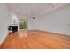 Open living room showcasing the fireplace, wood floors, and natural light at 3044 Red Oak Ct # 204, Palm Harbor, FL 34684