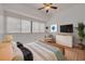 Cozy main bedroom with a large window, hardwood flooring, and warm, inviting decor at 3044 Red Oak Ct # 204, Palm Harbor, FL 34684
