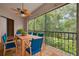 Cozy screened porch with dining table and comfortable seating overlooking the lush outdoors at 3044 Red Oak Ct # 204, Palm Harbor, FL 34684