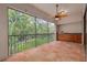 Spacious screened in porch with a ceiling fan, tiled floors, and a great view of the lush greenery outside at 3044 Red Oak Ct # 204, Palm Harbor, FL 34684