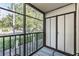 Relaxing screened balcony with seating and views of the community's lush greenery at 3055 Casa Del Sol Cir # 202, Clearwater, FL 33761