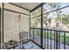 Cozy screened balcony with seating, offering a peaceful outdoor space with views of the surrounding landscape at 3055 Casa Del Sol Cir # 202, Clearwater, FL 33761