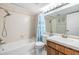 Clean bathroom featuring a shower-tub combo, vanity with sink, and ample lighting at 3055 Casa Del Sol Cir # 202, Clearwater, FL 33761