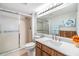 Bright bathroom featuring a glass-enclosed shower, modern vanity, and decorative accents at 3055 Casa Del Sol Cir # 202, Clearwater, FL 33761