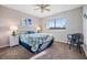 Cozy bedroom with natural light, ceiling fan, and decorative coastal themed accents at 3055 Casa Del Sol Cir # 202, Clearwater, FL 33761