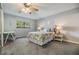 Serene bedroom with a large window, a ceiling fan, and tasteful decor creating a relaxing atmosphere at 3055 Casa Del Sol Cir # 202, Clearwater, FL 33761