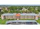 Wide, full exterior view of the condo building showing landscaping, balconies, and covered parking at 3055 Casa Del Sol Cir # 202, Clearwater, FL 33761