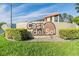 A ground-level view of the Casa del Sol community sign on a stucco wall near street at 3055 Casa Del Sol Cir # 202, Clearwater, FL 33761