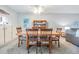 Dining room with wooden table and chairs, and a display cabinet at 3055 Casa Del Sol Cir # 202, Clearwater, FL 33761