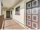 Condo unit entrance featuring a brown door with white trim and adjacent window at 3055 Casa Del Sol Cir # 202, Clearwater, FL 33761