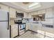 Bright kitchen with stainless steel appliances and white cabinets at 3055 Casa Del Sol Cir # 202, Clearwater, FL 33761