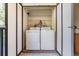 Convenient laundry closet with washer and dryer units and shelving for storage at 3055 Casa Del Sol Cir # 202, Clearwater, FL 33761