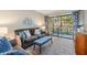 Comfortable living space with stylish decor and a sliding glass door to the lanai offering plenty of natural light at 3055 Casa Del Sol Cir # 202, Clearwater, FL 33761