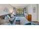 Inviting living room featuring neutral tones, comfortable seating, and a sliding glass door leading to the balcony at 3055 Casa Del Sol Cir # 202, Clearwater, FL 33761