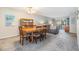 Open-concept living room and dining area with stylish decor and ample natural light from the sliding doors to the lanai at 3055 Casa Del Sol Cir # 202, Clearwater, FL 33761