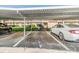 Assigned covered parking with view of the building, mailboxes and landscaping at 3055 Casa Del Sol Cir # 202, Clearwater, FL 33761