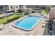 Community pool area with lounge chairs and well-maintained landscaping at 3055 Casa Del Sol Cir # 202, Clearwater, FL 33761