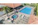 Aerial view of a community pool and hot tub area with ample seating and landscaping at 3055 Casa Del Sol Cir # 202, Clearwater, FL 33761