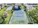 Overhead shot of a community tennis court with a pool and parking in the background at 3055 Casa Del Sol Cir # 202, Clearwater, FL 33761