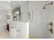 Modern bathroom with walk-in shower, rainfall shower head, and soaker tub in background at 3125 Christophers Watch Ln, Ruskin, FL 33570