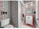 Stylish bathroom with designer wallpaper, glass shower, and decorative tiles at 3125 Christophers Watch Ln, Ruskin, FL 33570