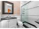 Well-appointed bathroom with a glass-enclosed shower, black and white tile, and modern fixtures at 3125 Christophers Watch Ln, Ruskin, FL 33570