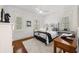 Bedroom with hardwood floors, black iron bed frame, and ample natural light at 3125 Christophers Watch Ln, Ruskin, FL 33570