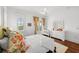 Bright bedroom with floral curtains, a ceiling fan, and a balcony, combining comfort and scenic views at 3125 Christophers Watch Ln, Ruskin, FL 33570