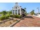 Quaint Little Harbor guardhouse with brick-paved path and lush landscaping, offering a welcoming entrance at 3125 Christophers Watch Ln, Ruskin, FL 33570