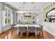 Dining room featuring a white table, stylish pendant lights, and an open view to a chef's kitchen at 3125 Christophers Watch Ln, Ruskin, FL 33570