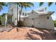 Stately white house with a 3-car garage, paver driveway, and lush tropical landscaping at 3125 Christophers Watch Ln, Ruskin, FL 33570