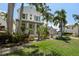 Charming two-story home featuring well-manicured lawn and tropical landscaping at 3125 Christophers Watch Ln, Ruskin, FL 33570