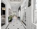 Bright hallway with black and white tile, transom windows, and elegant decor at 3125 Christophers Watch Ln, Ruskin, FL 33570