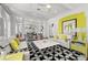 Bright living room with patterned rug, stylish furniture, and an open view to the adjacent kitchen at 3125 Christophers Watch Ln, Ruskin, FL 33570