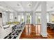 Spacious living room with hardwood floors, white columns, and ample natural light at 3125 Christophers Watch Ln, Ruskin, FL 33570