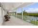 Spacious covered patio with ceiling fans, wicker chairs, and beautiful views of the waterway at 3125 Christophers Watch Ln, Ruskin, FL 33570