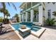 Inviting pool and spa area with elegant tile accents and outdoor seating at 3125 Christophers Watch Ln, Ruskin, FL 33570