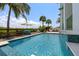 Beautiful pool with a spa, surrounded by lush landscaping and a waterfront view, for ultimate relaxation at 3125 Christophers Watch Ln, Ruskin, FL 33570