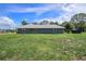 A well-maintained backyard with lush green grass surrounding the home is perfect for outdoor activities at 31645 Bugle Ln, Wesley Chapel, FL 33543