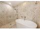 Contemporary bathroom featuring a standalone tub and glass-enclosed shower with designer tile at 31645 Bugle Ln, Wesley Chapel, FL 33543